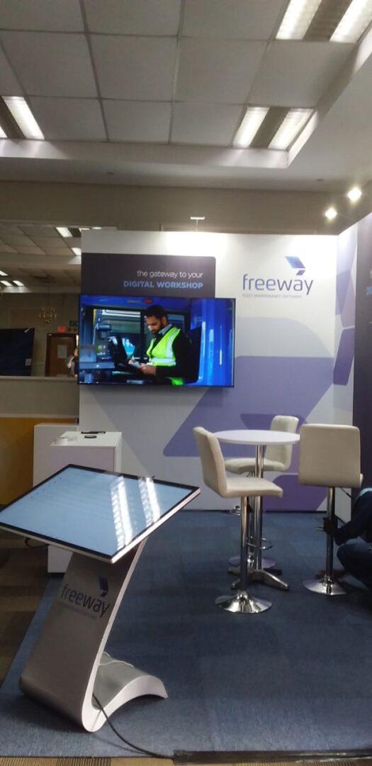 EBS custom-built event stand with flooring, furniture, and lighting setup